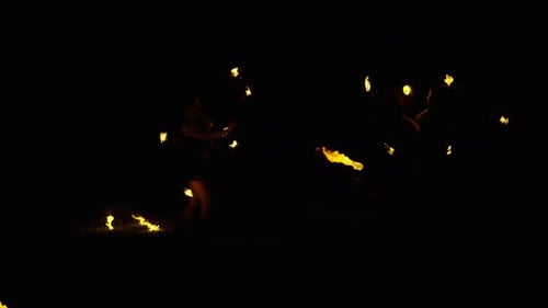 Women Perform Dynamic Fire Spinning Artistry at Night