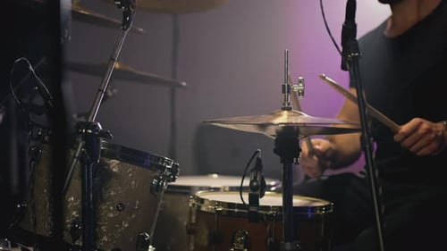 Drummer Playing Drum Set in Dark Music Studio