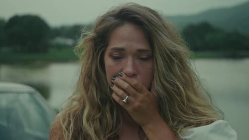 An Emotional Scene By the Water A Heartfelt Moment of Distress and Vulnerability