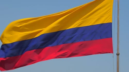 Big Columbian flag waving in the wind on bright summer's day