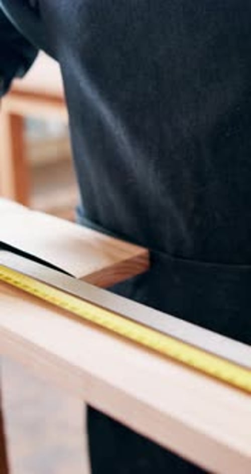 Carpenter, plank and hands with tape measure, project and woodwork or construction