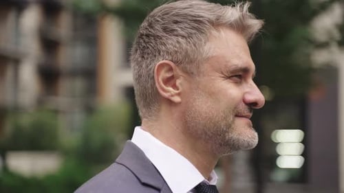 Smiling Adult Businessman Posing in the City Real Time Concept