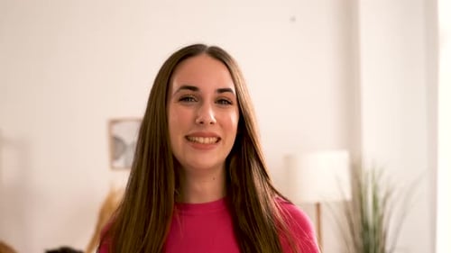Smiling Brunette Woman With Long Hair In Home