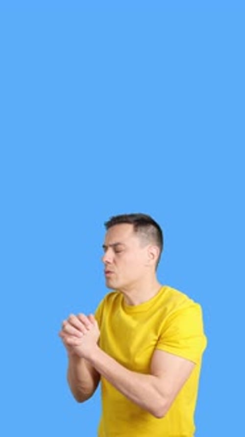 Man Praying Holding Hands and Looking Up in Despair