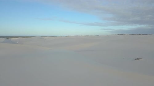 Aerial of man hiking on sand dunes in South Africa