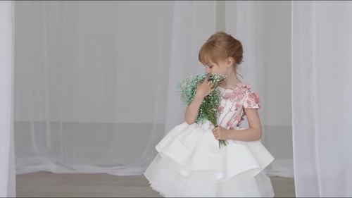 Girl in White Dress Holding Flowers