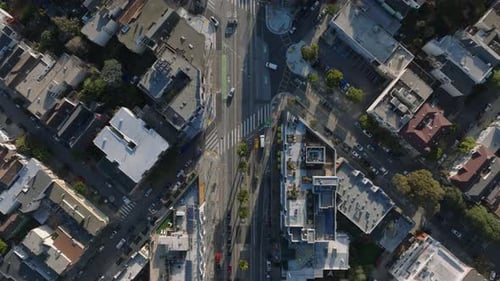Top Down Panning Footage of Cars Passing Through Road Intersection in City