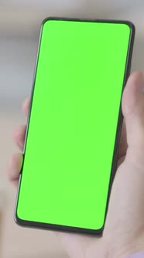 Smartphone in Hand with Green Chroma Screen, Vertical Video