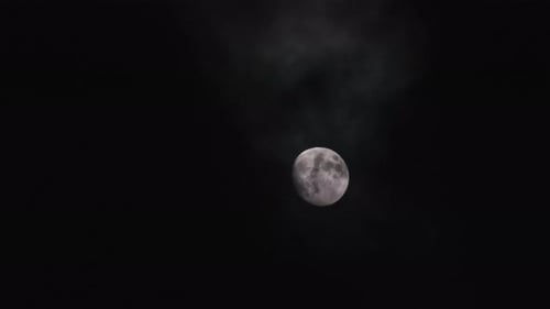 Full Moon Shines in Cloudy Night Sky