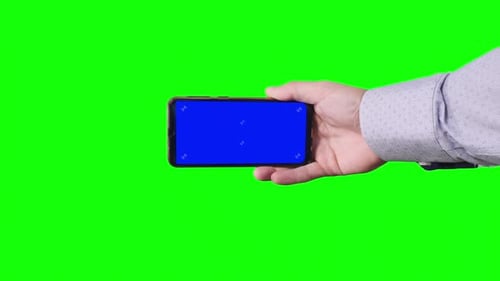Male Hand Holding Smartphone with Blue Screen with Markers on Green Background