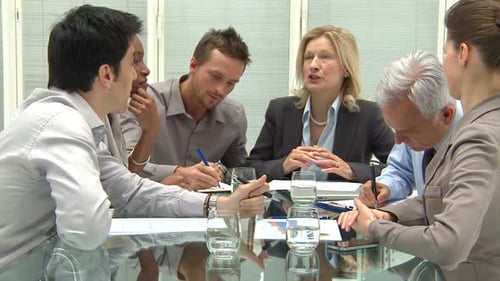 Business team discussing strategy and profit in modern office conference room