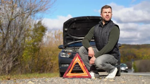Frustrated Man on Road with Broken Car