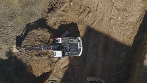 Excavator Fills Dump Truck at Construction Site