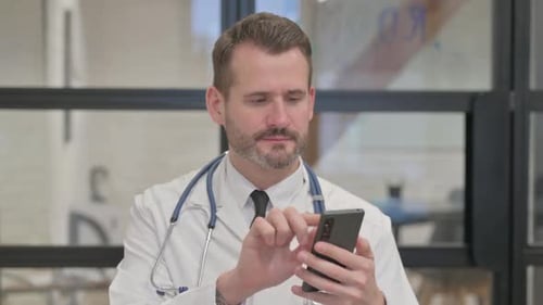 Doctor Using Smartphone in Modern Clinic Setting