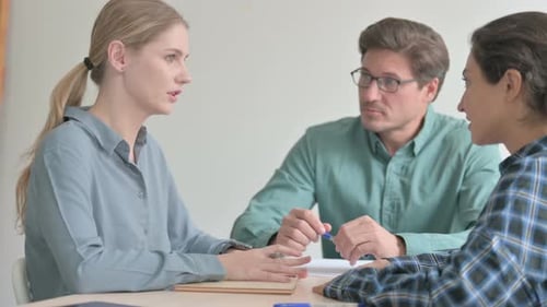 Three Colleagues Having a Meeting at Work
