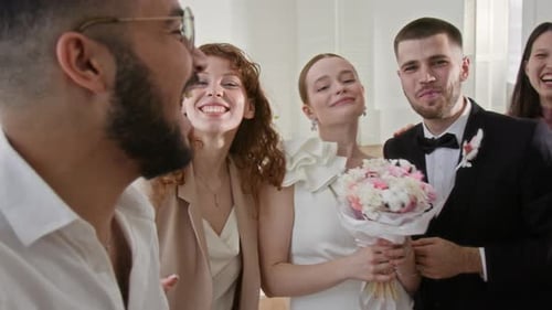 Guest Holding Camera and Recording Video of Wedding Day