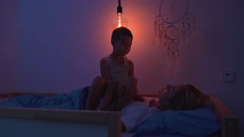 Mother and Young Boy Spend Time in Bedroom