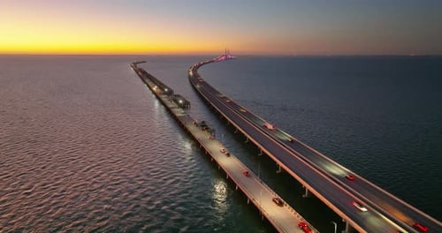 Highway Road Traffic Driving at Sunset Over Sunshine Skyway Bridge in Florida Transportation