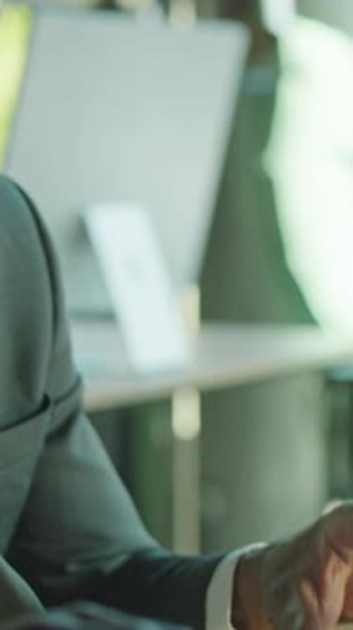 A Man in Business Attire Posed Calmly Under Soft Lighting Creating a Reflective Mood