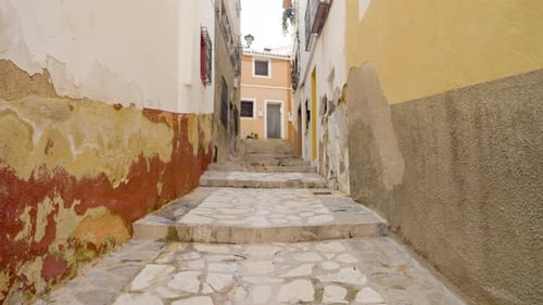Narrow street and cobbles stairs in colourful Spanish holiday town