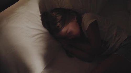 Girl Sleeping Peacefully in Bed at Night