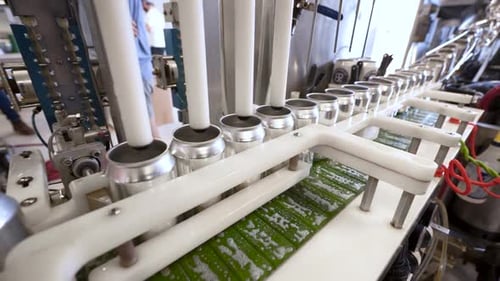 Cans Being Filled and Processed on Assembly Line