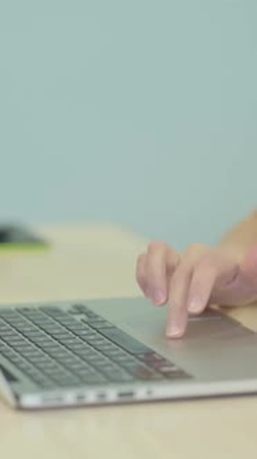 Side View of Hands Typing on Laptop, vertical video
