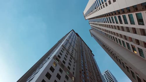 Bottomup View of Tall Skyscrapers with Blue Sky in the Background