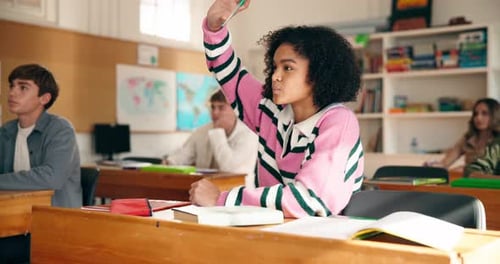Teen Student Raises Hand in Classroom at School