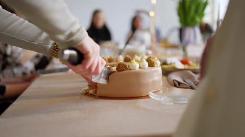 Woman Cutting a Birthday Cake with Cream Decoration
