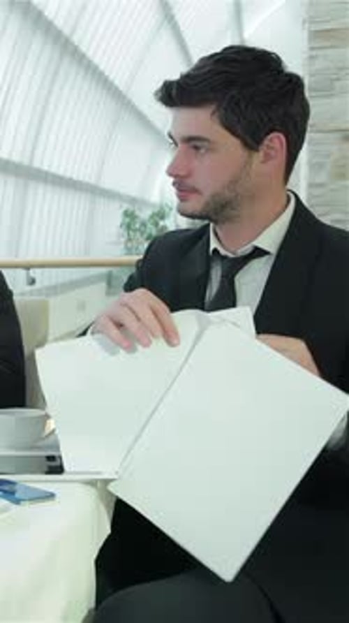 Dynamic Teamwork Among Four Smiling Businessmen in a Modern Office