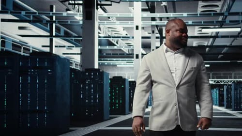 Smiling Manager in Data Center Doing Checkup on Hardware to Avoid Downtime