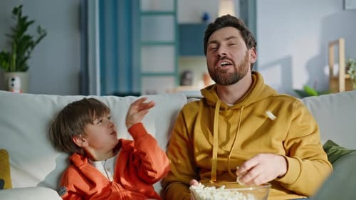 Father and Son Bonding Watching Television at Home