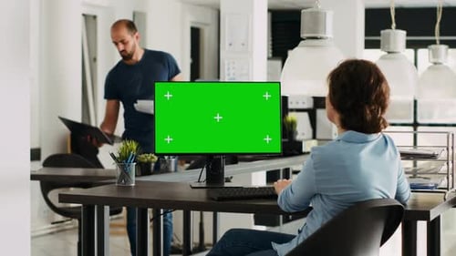 Woman Works at Desk With Green Screen Computer
