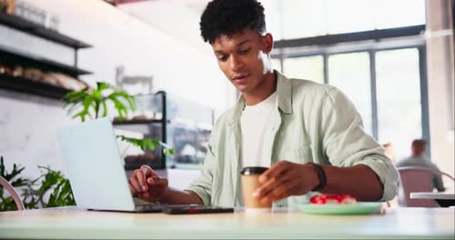 Laptop, coffee and man in cafe working on creative freelance project with internet