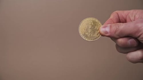 Hand Holding Gold Bitcoin Digital Currency