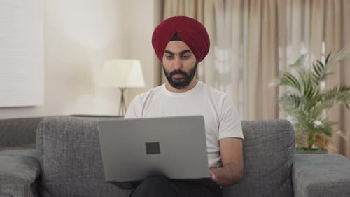 Un manager indien sikh passe un appel vidéo sur un ordinateur portable