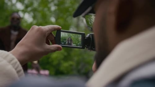 Man Being Filmed With Handheld Video Camera