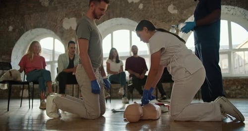 Closeup Shooting A Bearded Brunette Man in a Gray Tshirt Along with a Professional Female Doctor in