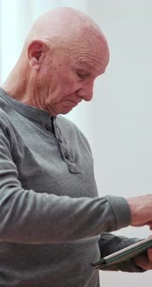Senior Man Using Tablet at Home