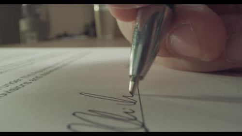 Macro Close up on a Signature being Given on a paper