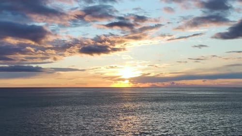 Aerial Video of Vibrant Twilight Colors Painting Evening Sky Over Calm Sea Horizon