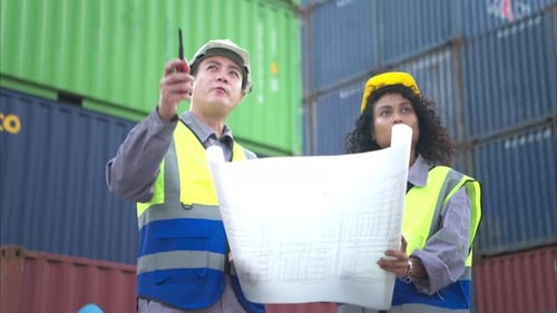 Man and Woman Reviewing Plans at Shipping Port