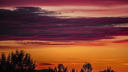 Dusky Clouds Slide Against Vibrant Sky During Sunset. Timelapse