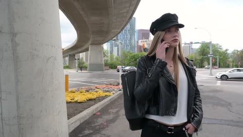Young Woman in Hat Using Smart Phone Under Urban Overpass 2024 Years