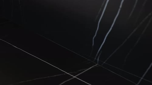 This is an Abstract Dark Surface Featuring a Subtle Light Reflection for an Artistic Ambiance