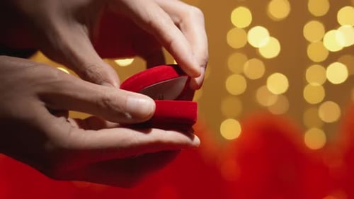 Close Up of Hands Opening Engagement Ring Box