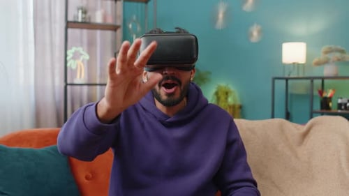 Young Adult Using Virtual Reality Headset on Couch