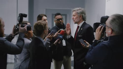 Politician Addressing Press in Hallway Interview