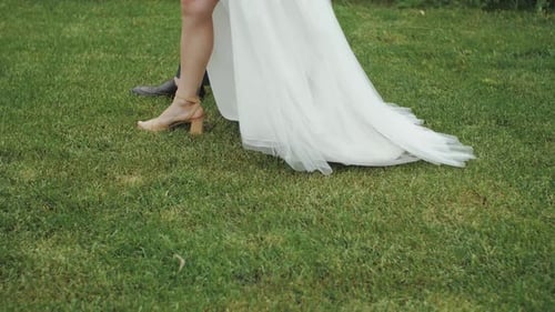 Wedding Couple Legs Close Up Bride and Groom Feet Walking on Green Grass Walk on Wedding Day High